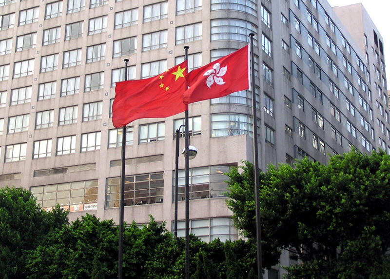 A larger Chinese flag flies behind a smaller Hong Kongese flag.
