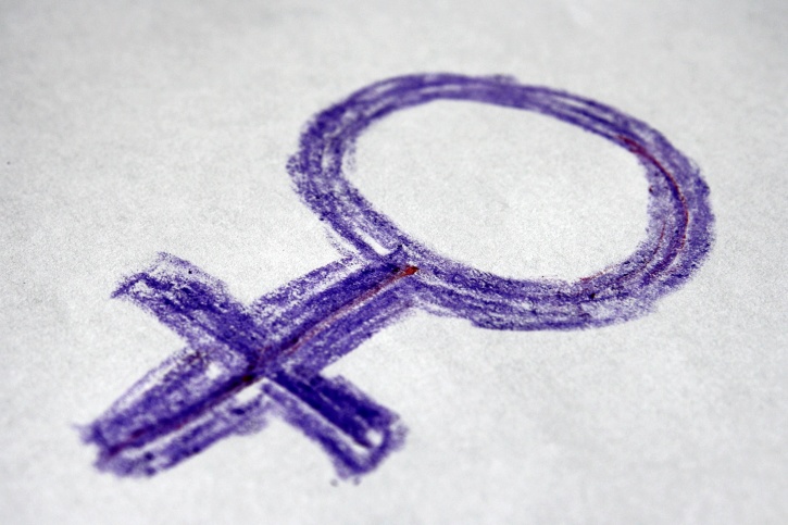 The "female"/Venus symbol, drawn sketchily in deep blue/purple crayon.