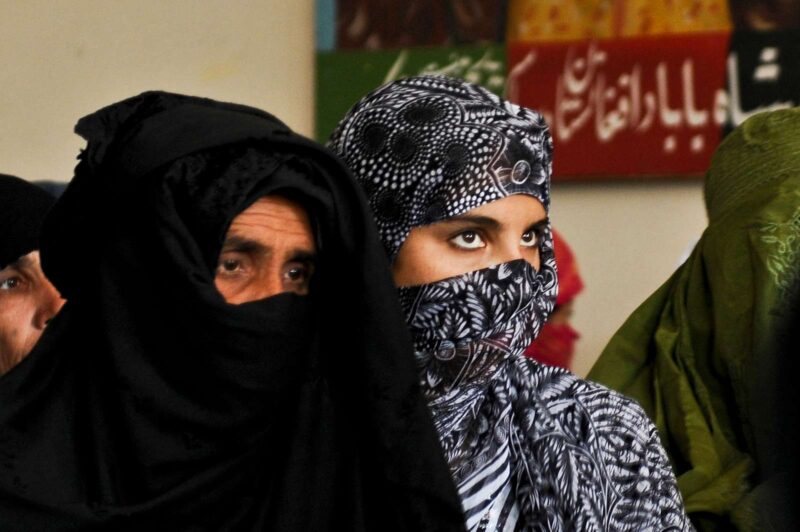 An Afghan woman listens intently during a speech at the 2010 Women’s Justice Shura.