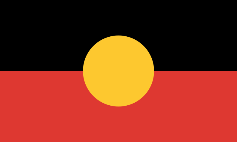 The aboriginal flag, a gold circle sitting between a black and red horizontal stripe like a sun sinking into a red sea.