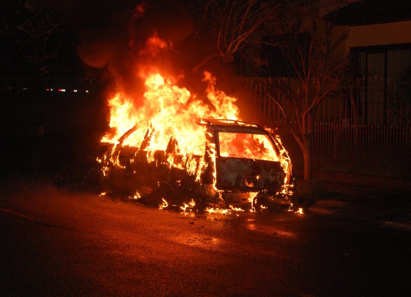 A photograph of a car on fire.